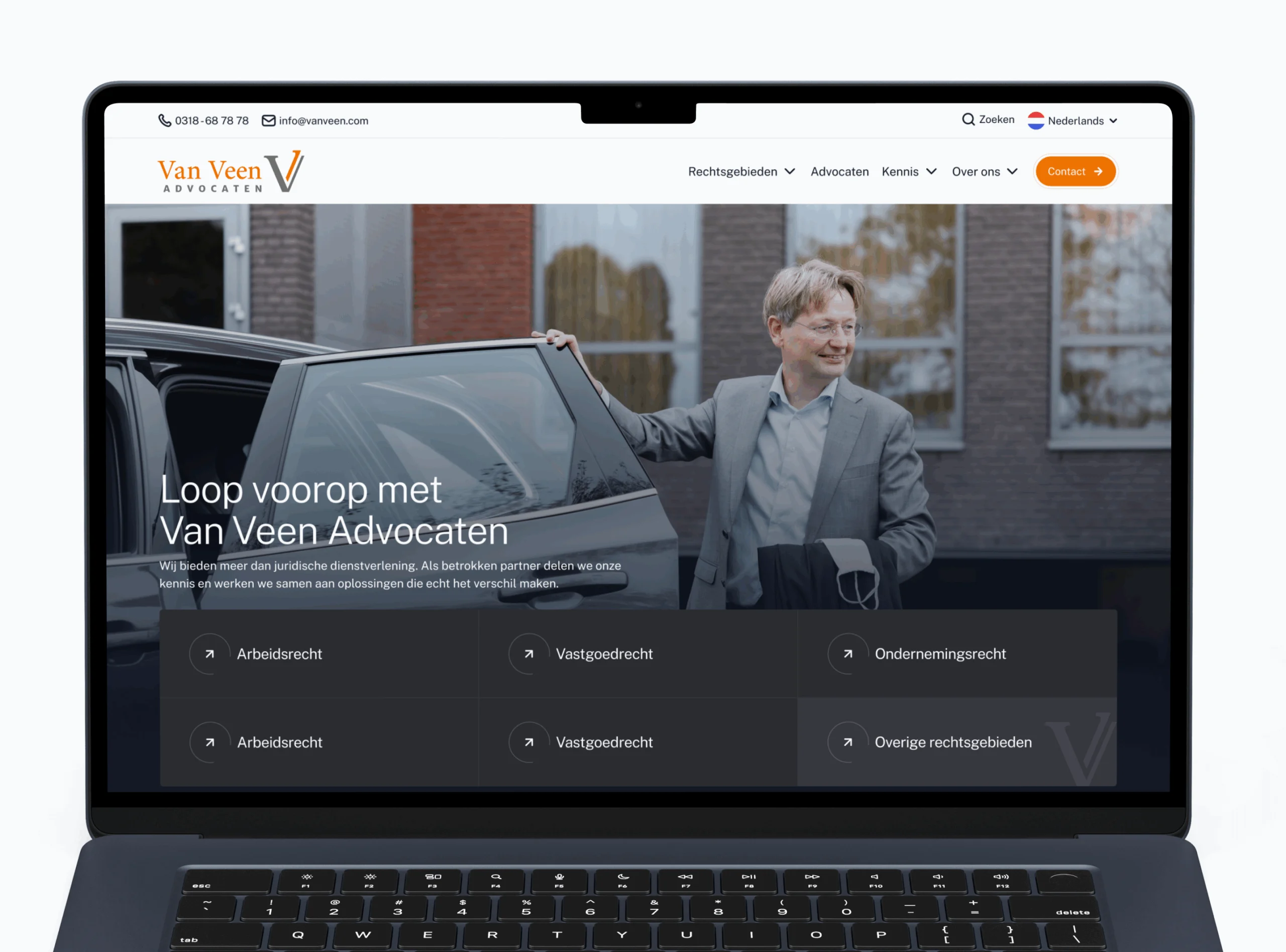 Laptop scherm toont Van Veen Advocaten website met man in grijs pak die autodeur opent